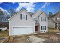 Two-story house featuring a two-car garage and manicured lawn at 3111 Hendricks Chapel Ln, Charlotte, NC 28216