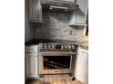 Modern stainless steel Frigidaire oven and hood fan set against a tile backsplash and granite countertops at 3605 Truxton Ct, Waxhaw, NC 28173