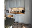 Beautiful kitchen with gray cabinets, butcher block countertops, and stainless steel appliances at 3605 Truxton Ct, Waxhaw, NC 28173