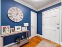 Entryway with blue walls, hardwood floors, and a console table at 6716 Ronda Ave, Charlotte, NC 28211