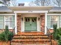 Brick front entrance with double doors, flanked by columns and greenery at 6716 Ronda Ave, Charlotte, NC 28211