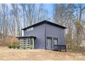 Stylish dark gray home with large windows and deck at 7117 W Sugar Creek Rd, Charlotte, NC 28269