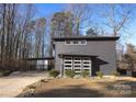 Modern dark gray house with attached garage and landscaping at 7117 W Sugar Creek Rd, Charlotte, NC 28269