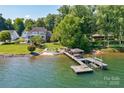 Waterfront property featuring a private dock and sandy beach at 8191 Deep Water Ln, Denver, NC 28037