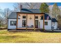 Stylish white exterior, covered porch, and beautiful landscaping at 910 S College Ave, Newton, NC 28658