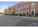 Charming street view of brick townhomes in a desirable community setting at 9223 Belcaro Ln, Charlotte, NC 28273