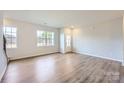 Bright living room with hardwood floors and large windows at 9858 Old Garden Cir, Gastonia, NC 28056