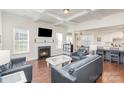 Living room with kitchen views, fireplace and hardwood floors at 11618 Macallano Dr, Charlotte, NC 28215