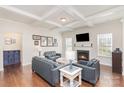 Spacious living room with fireplace, hardwood floors, and coffered ceiling at 11618 Macallano Dr, Charlotte, NC 28215