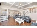 Open floor plan living room with kitchen views and hardwood floors at 11618 Macallano Dr, Charlotte, NC 28215