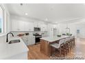 Open kitchen featuring a large island with bar seating and modern appliances at 12009 Garmon Mill Estates Dr # 2P, Stanfield, NC 28163