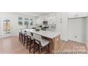Modern kitchen with white cabinetry, a large island, and stainless steel appliances at 12009 Garmon Mill Estates Dr # 2P, Stanfield, NC 28163