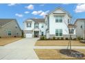 Charming two-story home with well-manicured landscaping and a spacious driveway leading to a two-car garage at 13020 Hindcross Dr, Huntersville, NC 28078