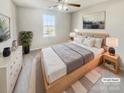 Virtually staged main bedroom with wood platform bed and neutral decor at 17015 Greenlawn Hills Ct, Charlotte, NC 28213