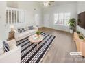 Virtually staged living room features hardwood floors and stylish furnishings at 17015 Greenlawn Hills Ct, Charlotte, NC 28213