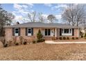 Brick ranch home with black shutters and landscaping at 1935 Berkshire Dr, Gastonia, NC 28052