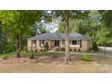 Ranch home with brick exterior and tree-lined street at 1935 Berkshire Dr, Gastonia, NC 28052