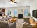 Virtually staged living room with fireplace, hardwood floors, and ample natural light at 3744 Amber Meadows Dr, Charlotte, NC 28269