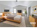 Virtually staged main bedroom with wood-look flooring and large windows at 3744 Amber Meadows Dr, Charlotte, NC 28269