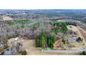 Aerial view of the property showing the lot lines, wooded areas, and solar panels at 4530 Meandering Way, Conover, NC 28613