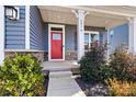 Red front door entrance with stone accents and landscaping at 6270 Durango Way, Denver, NC 28037