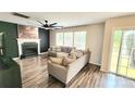 Cozy living room featuring a fireplace, a large sectional sofa, and sliding doors to the deck at 712 Georgie St, Troutman, NC 28166