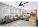 Open-concept living room with natural light, large sectional, and view of the kitchen with a wooden island at 712 Georgie St, Troutman, NC 28166