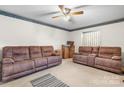 Cozy living room featuring neutral carpet, ceiling fan, and comfortable brown sofas at 906 16Th Nw St, Conover, NC 28613