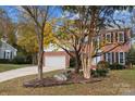 Lovely two-story home with a well-manicured front yard, large driveway, and attached garage at 10015 Lattice Ct, Charlotte, NC 28269