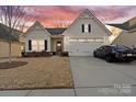 Stunning curb appeal with a two-car garage and manicured lawn at 10356 Black Locust Ln, Harrisburg, NC 28215