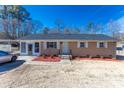 Charming single-story home with brick facade, updated roof, fresh landscaping, and a welcoming entrance at 1221 S Myrtle School Rd, Gastonia, NC 28052