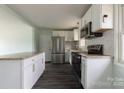 Modern kitchen featuring stainless steel appliances, granite countertops, and white cabinets at 1221 S Myrtle School Rd, Gastonia, NC 28052