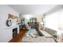 Cozy living room featuring a white brick fireplace and eclectic decor at 1223 India Hook Rd, Rock Hill, SC 29732