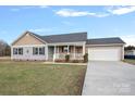 Ranch style home with gray siding, attached garage, and a porch at 130 Portman Ln, Statesville, NC 28625