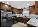 Spacious kitchen featuring dark wood cabinets, granite countertops, and stainless steel appliances at 130 Portman Ln, Statesville, NC 28625