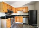 Kitchen with wood cabinets, granite counters, and stainless steel appliances at 1419 Riverwood Ct, Rock Hill, SC 29732