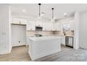 Modern kitchen with white cabinets, quartz countertops, and a large island at 1510 Nectar Way, Kannapolis, NC 28027