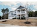 Two-story house with gray siding, a balcony, and a two-car garage at 15209 Red Canoe Way, Charlotte, NC 28278