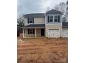 Two-story house with beige siding, gray accents, and a two-car garage at 1604 Lincoln Dr, Shelby, NC 28152