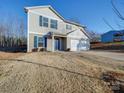 Two-story house with gray siding, blue door, and a spacious front yard at 162 Four Andrews Dr, Harmony, NC 28634