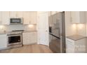 Stainless steel appliances and white cabinets in a spacious kitchen at 1819 Teachers House Nw Rd, Concord, NC 28027