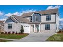 Charming two-story home featuring a two-car garage, stone accents, and a well-maintained lawn at 1852 Yardley St, Rock Hill, SC 29732