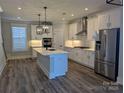 Modern kitchen featuring white cabinets, a large island, and stainless steel appliances at 1852 Yardley St, Rock Hill, SC 29732