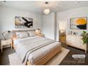 Bright bedroom with plush carpet, large windows, and ensuite bathroom at 1924 Felts Pkwy, Fort Mill, SC 29715