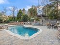 Gorgeous backyard pool and patio area with stone accents, outdoor seating, and a built-in grill, ideal for outdoor gatherings at 209 Choate Ave, Fort Mill, SC 29708