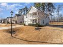 Two-story house with gray siding, a two-car garage, and a front porch at 232 Morgans Branch Rd, Belmont, NC 28012