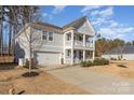 Two-story house with gray siding, a two-car garage, and a front porch at 232 Morgans Branch Rd, Belmont, NC 28012