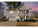 Charming two-story home with a welcoming front porch, attached garage, and well-maintained landscaping at 232 Morgans Branch Rd, Belmont, NC 28012