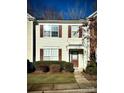 Front view of a light beige townhome with brown shutters and a walkway at 2711 Thornbush Ct, Charlotte, NC 28270