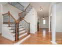 Bright foyer with hardwood floors, staircase, and decorative columns at 3013 Misty Moss Ct, Waxhaw, NC 28173